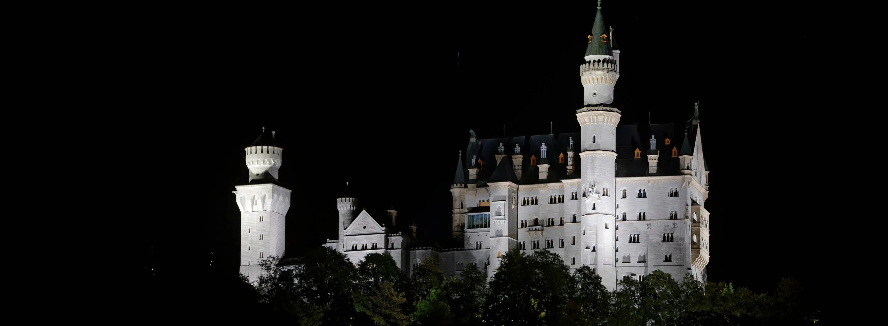 Close-up of Neuschwanstein Castle’s ornate towers and balconies in Bavarian sunlight